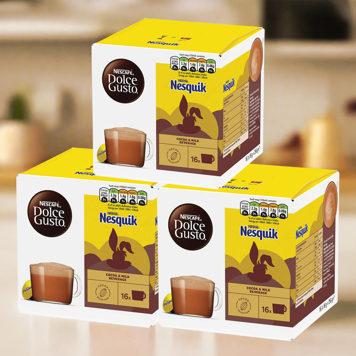 Three boxes of Nesquik and Dolce Gusto coffee packaging on a blurred background