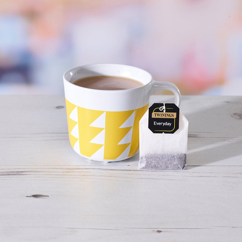 A cup of tea next to a Twinings Everyday String & Tag Tea Bag