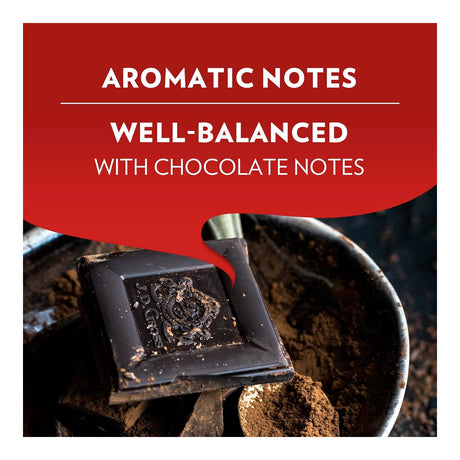 A promotional graphic with a red speech-bubble-style banner reading 'AROMATIC NOTES WELL-BALANCED WITH CHOCOLATE NOTES' over a photo of a dark chocolate bar resting in cocoa powder.
