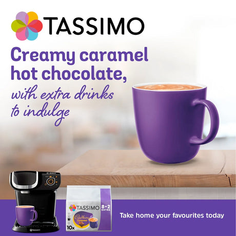 Tassimo coffee machine and purple mug with creamy caramel hot chocolate on a blurred background