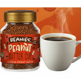 Jar of Beanies Peanut Butter Cup instant coffee next to a steaming white mug on an orange background