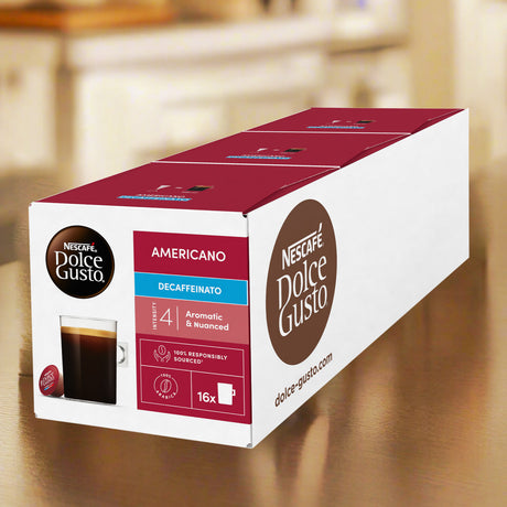 Box of Nescafe Dolce Gusto Americano Decaffeinated coffee pods on a wooden surface.