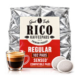 A package of Good Taste RICO Kaffepads Regular Compatible Pads, shown with a glass of espresso and two coffee pods in front of a white background.