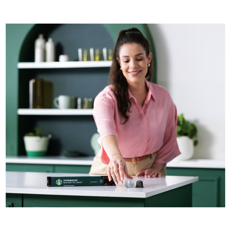 Woman in a kitchen setting with Starbucks Nespresso Ristretto Shot Coffee Pods