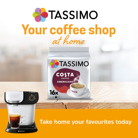 Tassimo coffee machine and Tassimo Costa Coffee packaging on a wooden surface with a blurred background.
