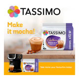 Tassimo Cadbury Mocha coffee packaging with a coffee machine and mocha cup on a wooden surface.