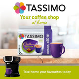 Tassimo coffee pod packaging with a cup and coffee machine on a wooden surface.