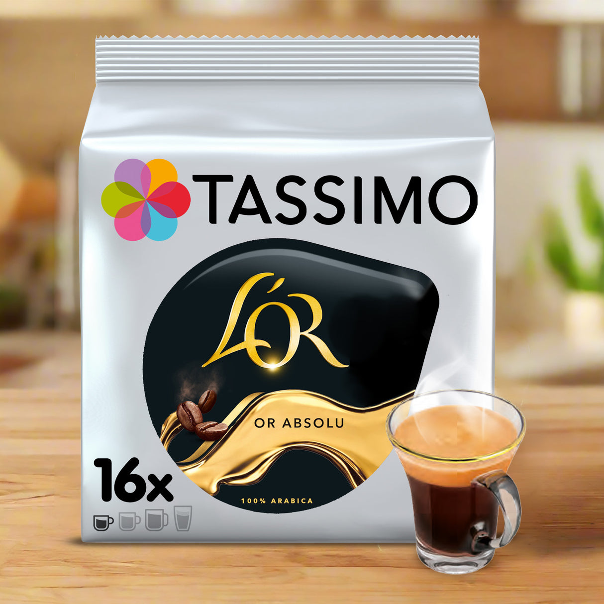 Tassimo L'Or Absolu coffee pod packaging with a glass of coffee on a wooden surface.