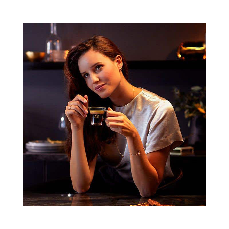 A woman holding an espresso